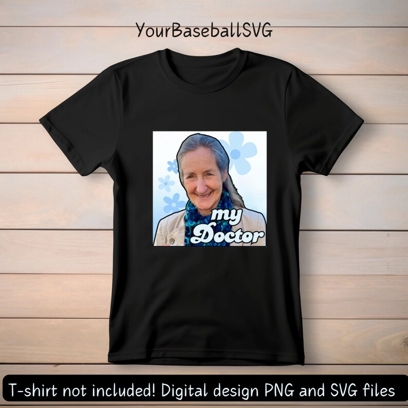 May include: Black t-shirt featuring a square graphic with a smiling woman, blue flowers, and the text "my Doctor." The design includes a light blue and white color scheme. The text "YourBaseballSVG" is at the top.