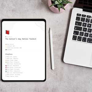May include: A digital tablet displays "The Artist's Way Notion Toolkit" with chapter titles like "Safety" and "Identity." A white stylus and a laptop are nearby. A small succulent in a pink pot sits on the gray surface.