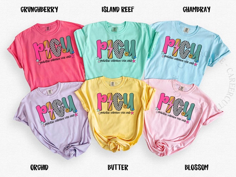 May include: A collection of six colorful t-shirts, each displaying the word "PICU" in a playful, multi-colored design with a lightning bolt and smiley face. The shirts come in various hues, including pink, blue, yellow, and purple.