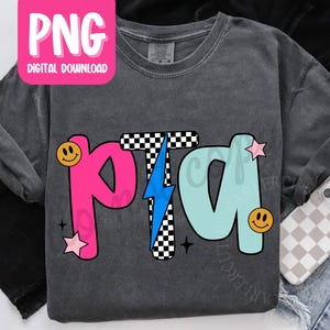 May include: Dark gray long-sleeve shirt with the letters "PTA" in pink, checkered, and light blue. The "T" is checkered with a blue lightning bolt. Smiley faces and stars accent the letters. A pink "PNG Digital Download" graphic is in the upper left.