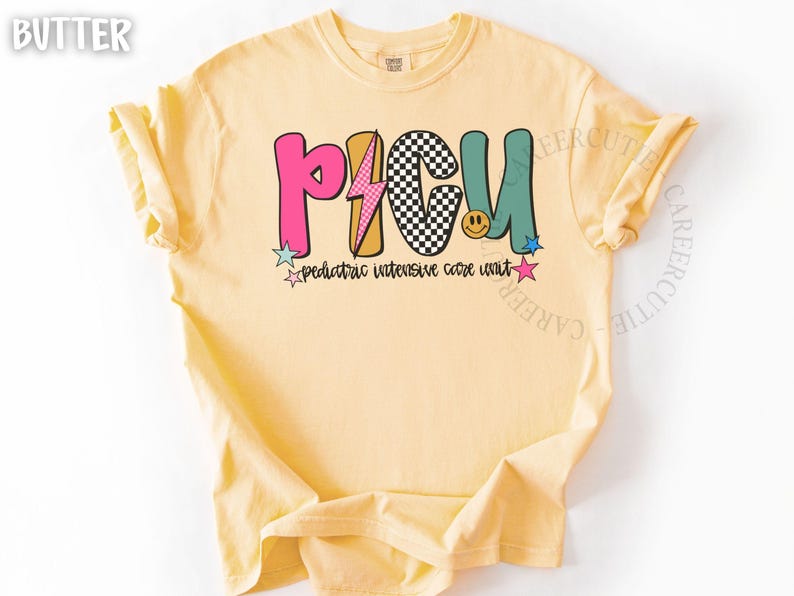 May include: Butter-colored t-shirt with the text "PICU" in colorful, playful letters. The design includes a lightning bolt, a checkerboard pattern, and a smiling face. Below the letters, it reads "pediatric intensive care unit."