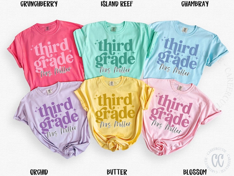 May include: Six t-shirts in shades of pink, blue, yellow, and purple. Each shirt has the text "third grade Mrs. Miller" printed on it. The shirts are arranged on a white surface, showcasing a range of colours and designs.