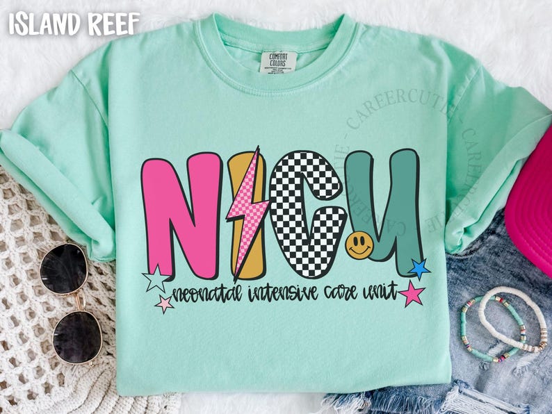 May include: A light green t-shirt with the text "NICU" in a colorful, retro design. The letters are pink, checkered, and teal, with a lightning bolt and smiley face. The words "neonatal intensive care unit" are below.