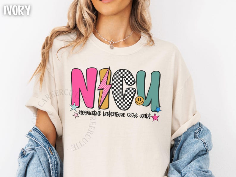 May include: Ivory-colored t-shirt with a colorful NICU graphic. The design features the letters "NICU" in pink, black and white checkered, and teal, with a lightning bolt and smiley face. The words "neonatal intensive care unit" are below.