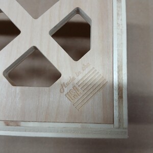 May include: A wooden box with a grid pattern and the text "Made in the USA" on the front.