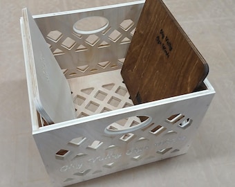 May include: A wooden crate with a lattice design and the words "Ohy Valley Free with me" engraved on the front. The crate is open and contains two wooden boards, one with the words "Stay true to your words" engraved on it.