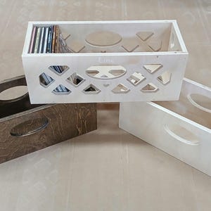 May include: Three wooden record crates, one with a cutout design and the word "Lime" on the front, and two with solid fronts. The crate with the cutout design is filled with vinyl records.