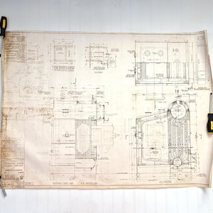 May include: Vintage blueprint with detailed technical drawings, likely for an industrial machine or structure. The blueprint is aged, with visible wear and tear, and features intricate line work and annotations. Two screwdrivers are holding the blueprint in place.