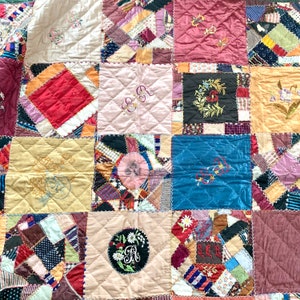 May include: A patchwork quilt with a variety of colors and patterns, including red, blue, pink, and yellow. The quilt is made up of squares and rectangles, and each square has a different design. The quilt is quilted with a simple stitch, and the edges are finished with a binding.