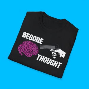 May include: Black t-shirt featuring the text "BEGONE THOUGHT" in white. A purple brain graphic is on the left, and a white hand holding a gun graphic is on the right.