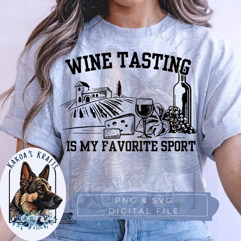 May include: A light gray short-sleeve t-shirt featuring a black graphic print of a vineyard, a wine glass, a bottle, and cheese. The text reads WINE TASTING IS MY FAVORITE SPORT. A small circular logo shows a German Shepherd dog with blue flowers.