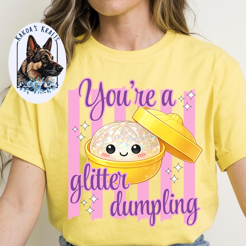 May include: Yellow t-shirt with a graphic of a glitter dumpling in a yellow bowl with a lid. The text "You're a glitter dumpling" is in purple script with pink stripes.