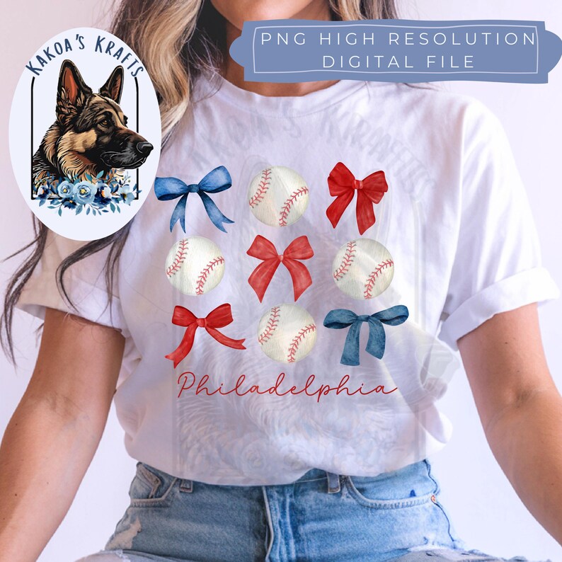 May include: White t-shirt with a watercolor design of baseballs, red, white, and blue bows, and the word "Philadelphia".