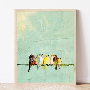 Five small birds sit close together on a wire. They each have different colored feathers representing a stylized Robin, Bluebird, Yellow Finch, sparrow, Wren. The birds are visually striking against the vivid yellow background of the art.