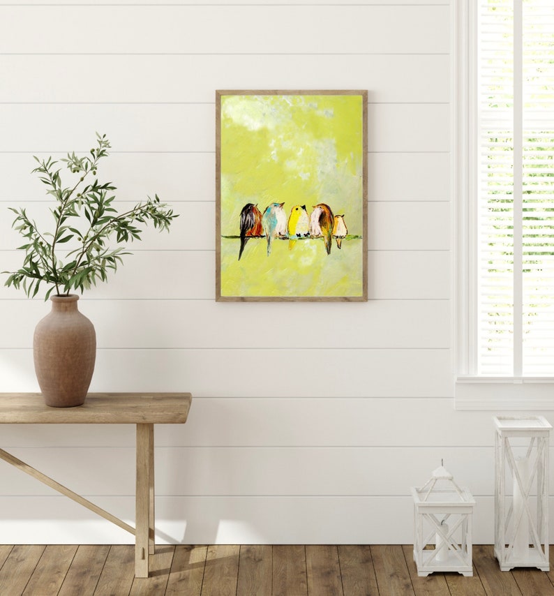 Five small birds of different feathers sit close together on a wire. There's a Robin, Bluebird, Yellow Finch, sparrow, and Wren stylized in a painterly way. The birds stand out against the cheerful yellow background of the art.