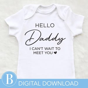 May include: White baby bodysuit with the text "HELLO Daddy I CAN'T WAIT TO MEET YOU" in black script. A small black heart is below the text. The words "DIGITAL DOWNLOAD" are at the bottom.