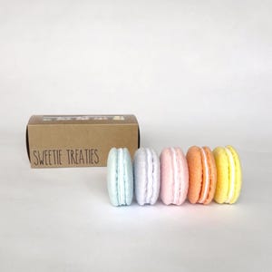 May include: A set of three ceramic mugs with a speckled, matte finish. Each mug features a different color: light blue, cream, and gray. The mugs have a simple, modern design, perfect for coffee or tea.