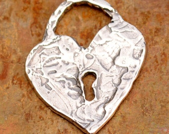 May include: A silver heart-shaped padlock pendant with a keyhole in the center. The pendant has a textured surface and a rustic look.