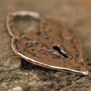 May include: A silver heart-shaped padlock with a keyhole. The padlock has a textured surface and a slightly worn appearance.