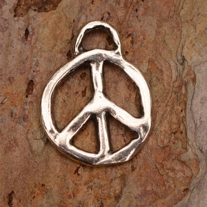 May include: A silver peace sign charm with a loop at the top for attaching to a necklace or bracelet.
