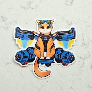 May include: A sticker featuring an orange tabby cat wearing goggles and a flight suit, riding a blue jet-powered device. The cat has a determined expression, with blue and yellow exhaust flames. The sticker is on a white background.