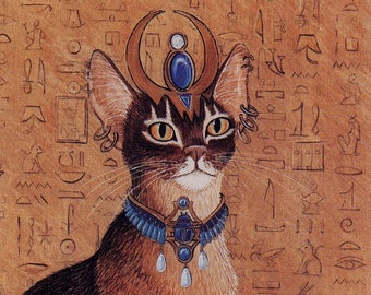 May include: A brown and black cat wearing a gold crown with blue jewels and a blue and gold collar with a scarab beetle pendant. The cat is sitting on a brown background with hieroglyphics.