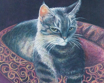 May include: A tabby cat with white markings sits in a decorative, ornate, red and gold circular frame. The cat has a serious expression and is looking directly at the viewer.