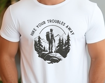 May include: White t-shirt with a black and white graphic of a hiker in a forest with the text "Hike Your Troubles Away".