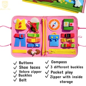 May include: A pink felt activity board with various interactive elements. Features include buttons, shoe laces, a Velcro zipper, buckles, and a belt. Additional elements are a compass, three different buckles, pocket play, and a zipper with inside storage.