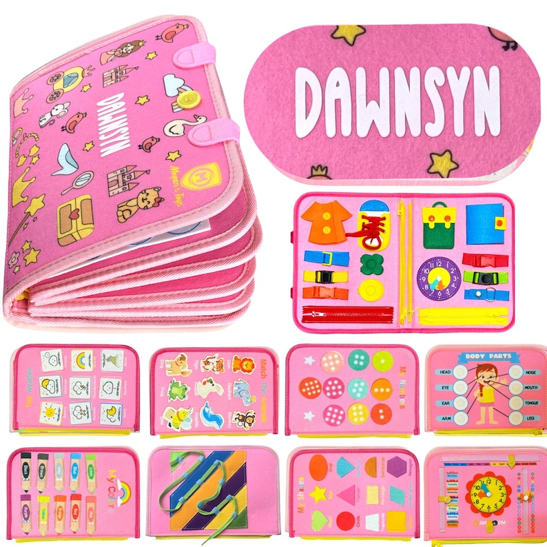 May include: A pink felt busy book featuring the name DAWNSYN on the cover. The book includes multiple interactive pages with various activities such as matching shapes, colors, buttons, zippers, buckles, a clock, and body parts identification.
