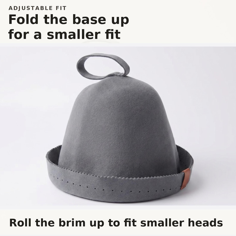 May include: A grey felt hat with a loop at the top and a folded brim featuring a small brown leather accent. Text at the top reads ADJUSTABLE FIT Fold the base up for a smaller fit. Text at the bottom reads Roll the brim up to fit smaller heads.
