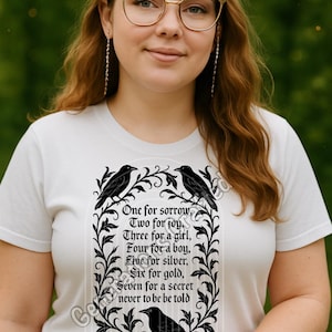 May include: White t-shirt with a black raven design and the text "One for sorrow, Two for joy, Three for a girl, Four for a boy, Five for silver, Six for gold, Seven for a secret never to be told." The shirt also has the text "GENERATIONS CRAFTED."
