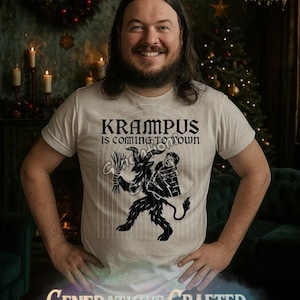 Op de afbeelding: Crèmekleurig T-shirt met de tekst "KRAMPUS IS COMING TO TOWN" boven een zwarte Krampus-afbeelding. De persoon die het T-shirt draagt, glimlacht. De achtergrond bevat een kerstboom en decoraties.