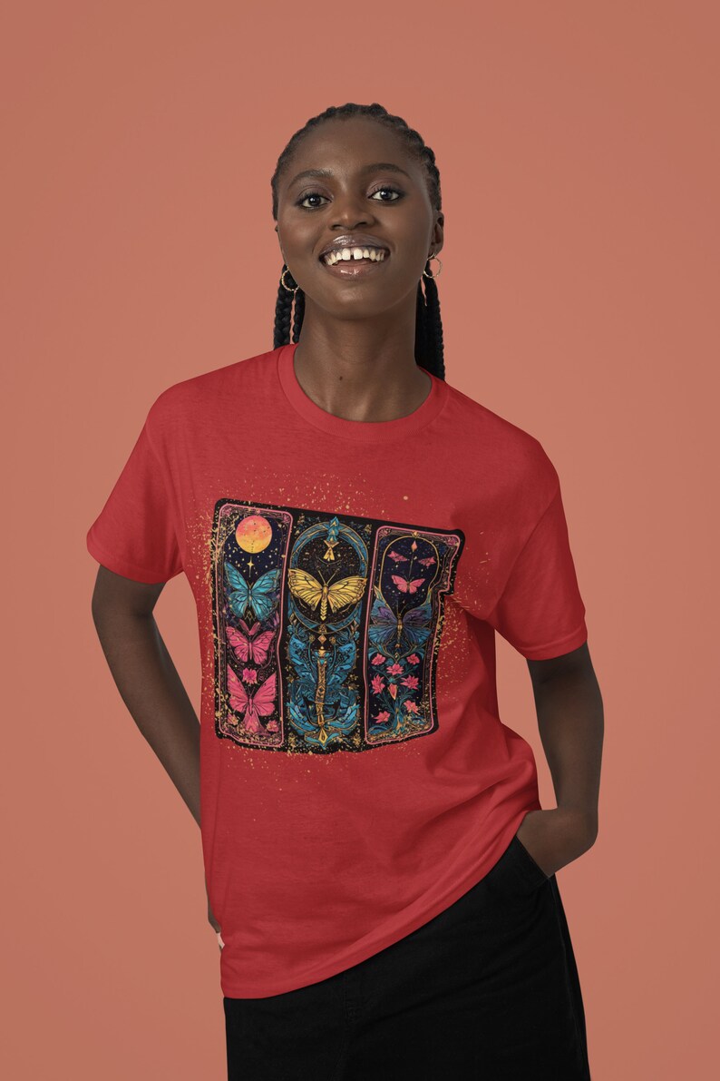 May include: Red t-shirt featuring a graphic of colourful butterflies in a stained glass style design.