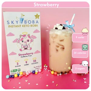 May include: A pink and white cartoon cow with angel wings holding a cup of boba tea. The packaging is for Sky Boba Instant Keto Boba in Strawberry flavor. The product is caffeine free and contains 3 grams of sugar, 9 grams of carbs, and 35 calories per serving. The image also shows a glass of strawberry boba tea with whipped cream and boba pearls.