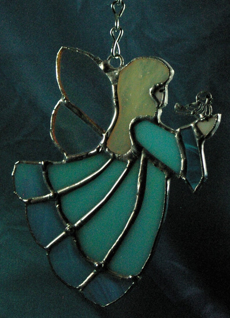 Handmade Blue Stained Glass Suncatcher Angel holding a bird on her hand.
