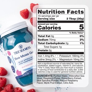 May include: A glass jar of True Sea Moss Gel in blue spirulina and raspberry flavor with a white lid. The label lists nutrition facts, including 5 calories per 2 tablespoon serving, and ingredients like purified water, sea moss, and raspberry puree.
