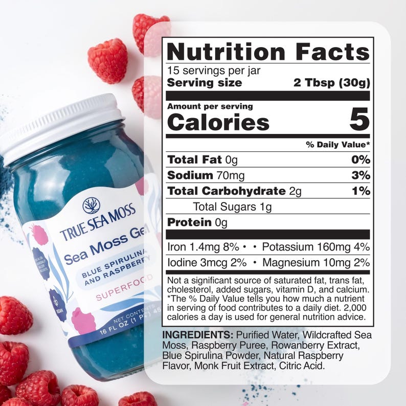 May include: A glass jar of True Sea Moss Gel in blue spirulina and raspberry flavor with a white lid. The label lists nutrition facts, including 5 calories per 2 tablespoon serving, and ingredients like purified water, sea moss, and raspberry puree.