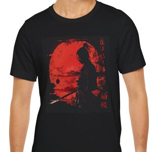 May include: Black t-shirt featuring a graphic of a samurai warrior in silhouette against a red sun. The Japanese characters "侍" and "魂" are printed on the shirt.