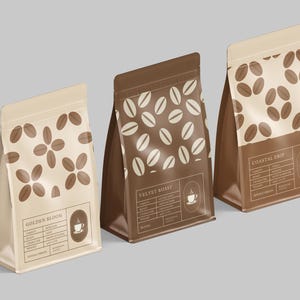 May include: Three coffee bags with different designs. The bags are brown and beige, with coffee bean patterns and text labels. One bag says "Golden Bloom", another "Velvet Roast", and the third "Coastal Drip". Each bag has a coffee cup icon.
