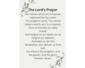 May include: A vertical rectangular wall hanging featuring The Lord's Prayer printed in black text on a light off-white background. The design is accented with watercolor-style green and grey leaves in the top-left and bottom-right corners.