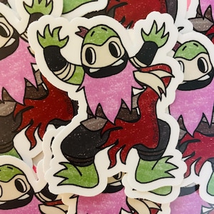 May include: A sticker featuring a cartoon character with green skin, a pink mohawk, and a black mask. The character is wearing a black and white outfit and is in a fighting pose. The sticker is on a white background.