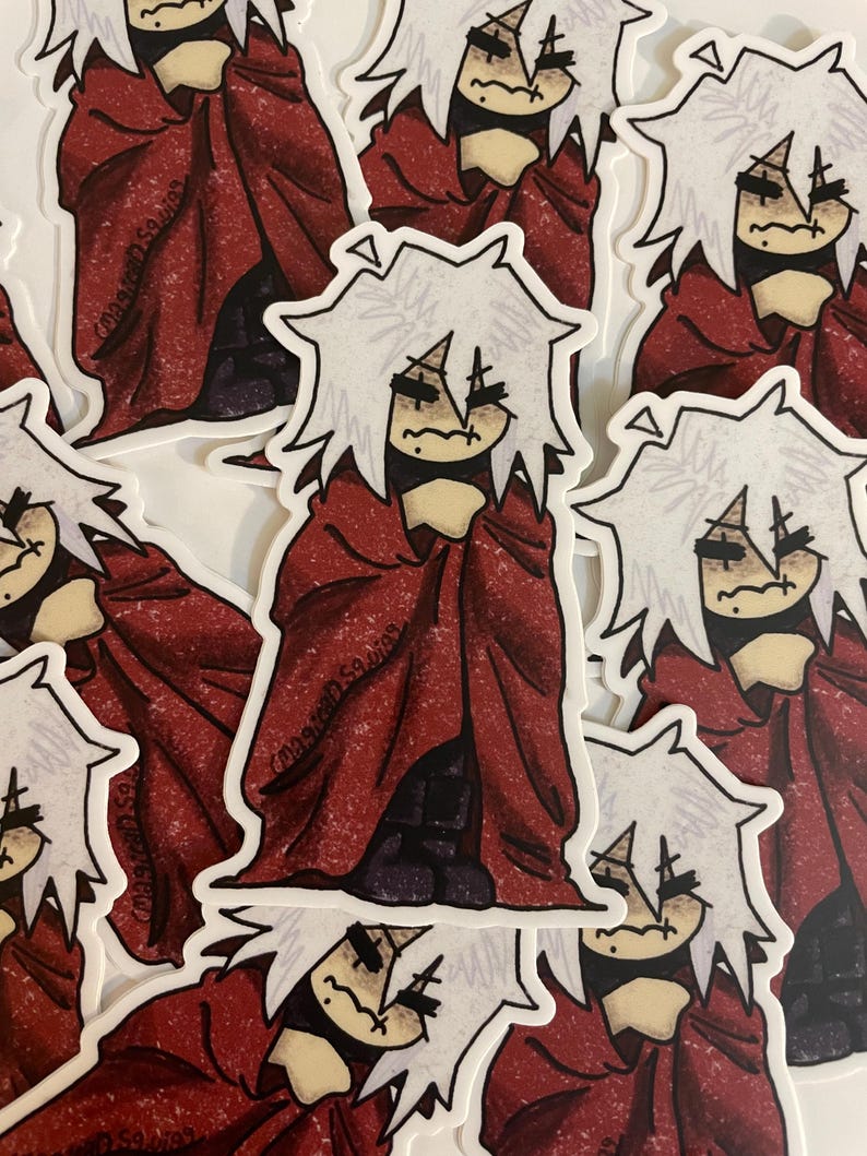 May include: A set of stickers featuring a white-haired character with a red cloak, drawn in a cartoon style. The character has a distressed expression and is holding the cloak around themself. The stickers are printed on white paper.
