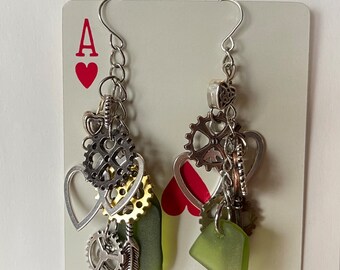 Steampunk earrings with green seaglass, hearts, key, gear cogs, feathers.  3 1/2” Long dangle boho charm seaglass earrings. Metal industrial
