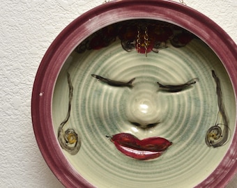 Decorative Plate With a Delightfully Peaceful Face in Celadon Ceramics by Anita Feng