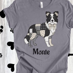 May include: Gray t-shirt featuring a dog design with a patchwork pattern in black, white, and tan. The dog has a bow tie and the name "Monte" is printed below. The shirt is on a wooden background with paw prints and dog bones.