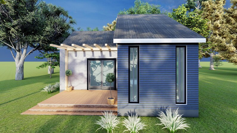Peut inclure: Une maison moderne avec un ext&eacute;rieur bleu et un toit gris fonc&eacute;. La maison dispose de grandes fen&ecirc;tres et d'une terrasse en bois. L'am&eacute;nagement paysager comprend des arbres et de l'herbe.