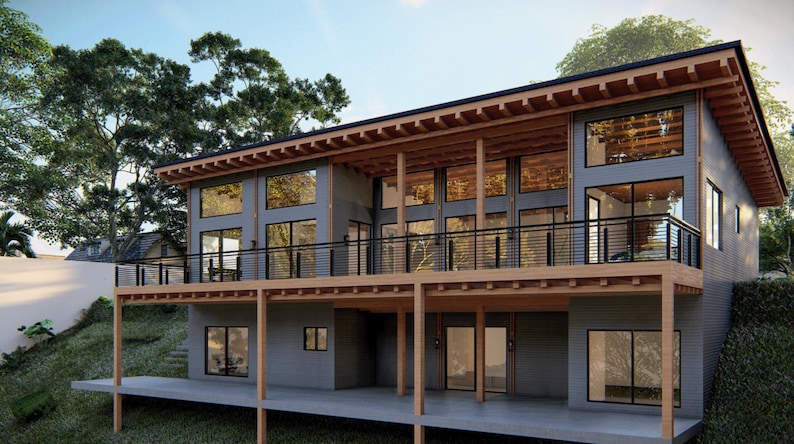 Puede incluir: Una casa moderna de dos pisos con una terraza de madera y grandes ventanas. La casa est&aacute; pintada de gris con vigas de madera y una barandilla negra.