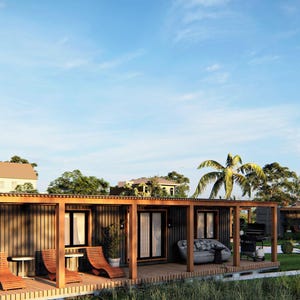 May include: A row of modern, wooden, prefabricated homes with a covered patio area. The homes have large windows and a light wood exterior.