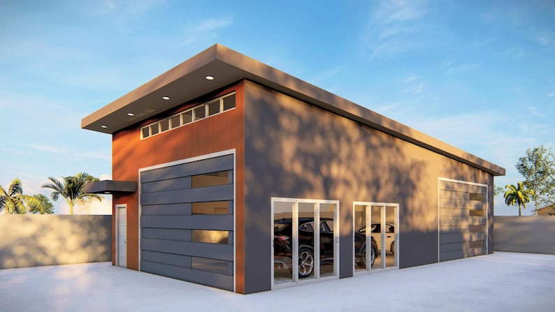 May include: A modern, two-car garage with a gray and orange exterior. The garage has a large, gray sectional garage door and two sets of glass doors. The garage is surrounded by a concrete driveway and a grassy lawn.